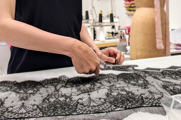 Angela Friedman cutting French lace in the lingerie sewing studio