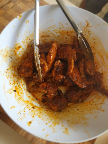 spicy chicken wings saucing