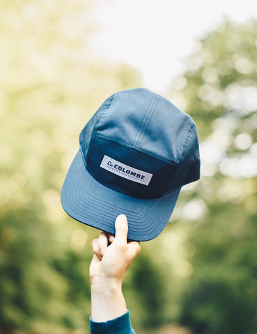 Image of someone holding up a La Colombe 5 Panel Hat.