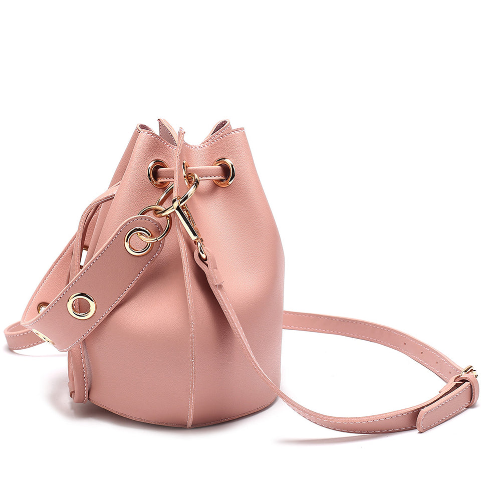 Eyelet drawstring faux leather bucket bag in Pink