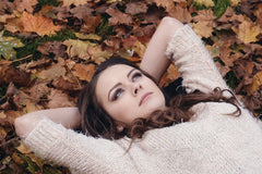 girl laying on leaves