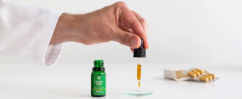 Scientist holding pipette of CBD Oral Spray