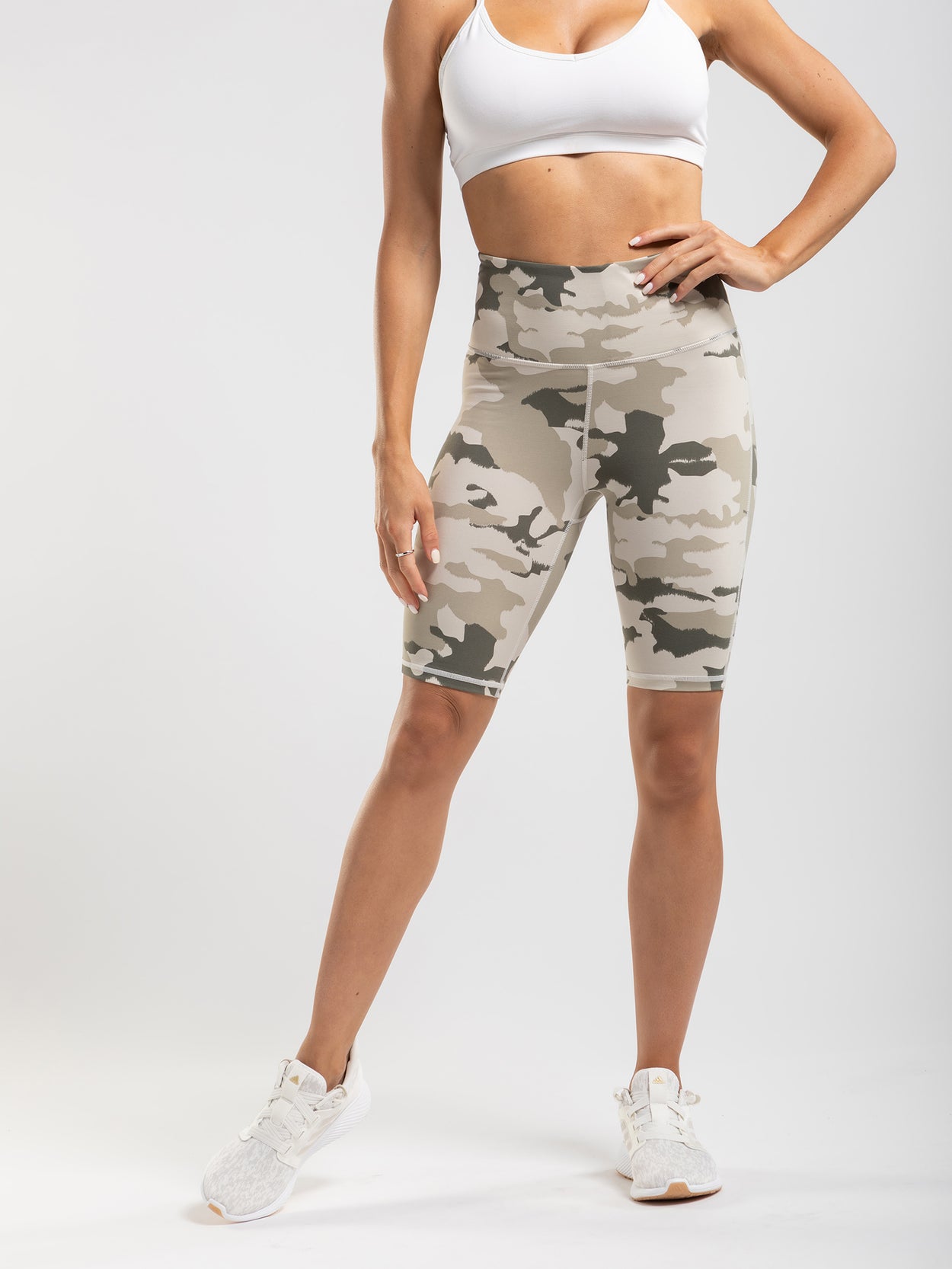 Camouflage print biker shorts with a high rise and interior pocket.