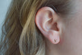 Tiny D studs - brass