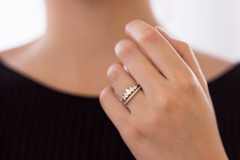 Crown Engagement Ring Set with Pear Cut Diamonds on Hand Angle One