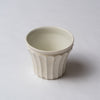 Yuko Matsuzuka, Cup with longitudinal flutes, cream glaze flecked with ochre