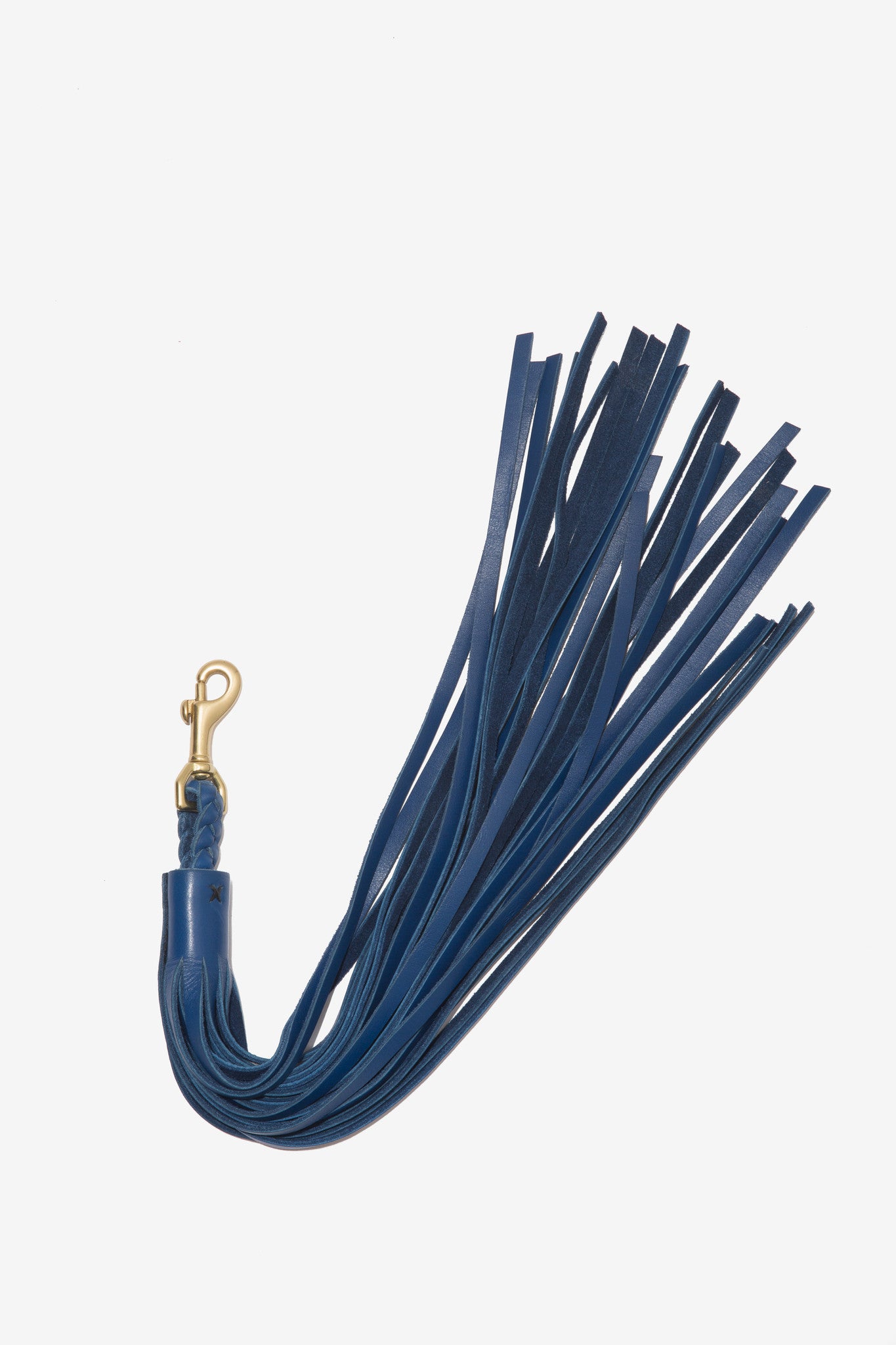 Tassel Charm is a black leather charm with gold hardware designed by Moses Nadel.