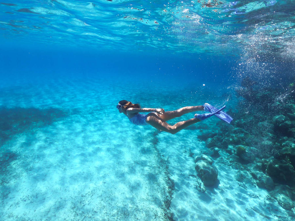 Underwater photography of a girl swimming in the Bahamas