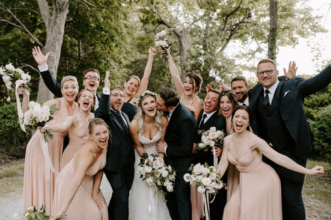 The Kelly's wedding party pose for a fun celebratory photo. Bridesmaids are wearing the Henkaa Sakura Maxi convertible dress in the popular colour Nude Champagne.