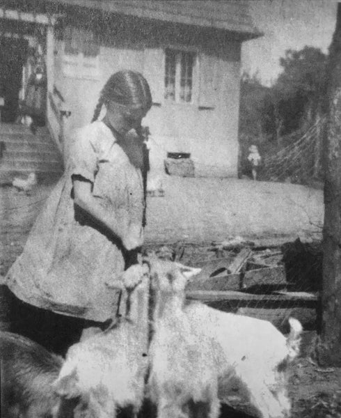 Gisela von Davidson feeding the goats in front of the Blisendorf farmhouse