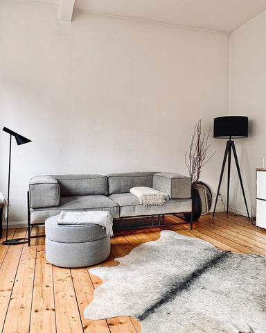 Light grey cow skin rug for modern living room trending these days