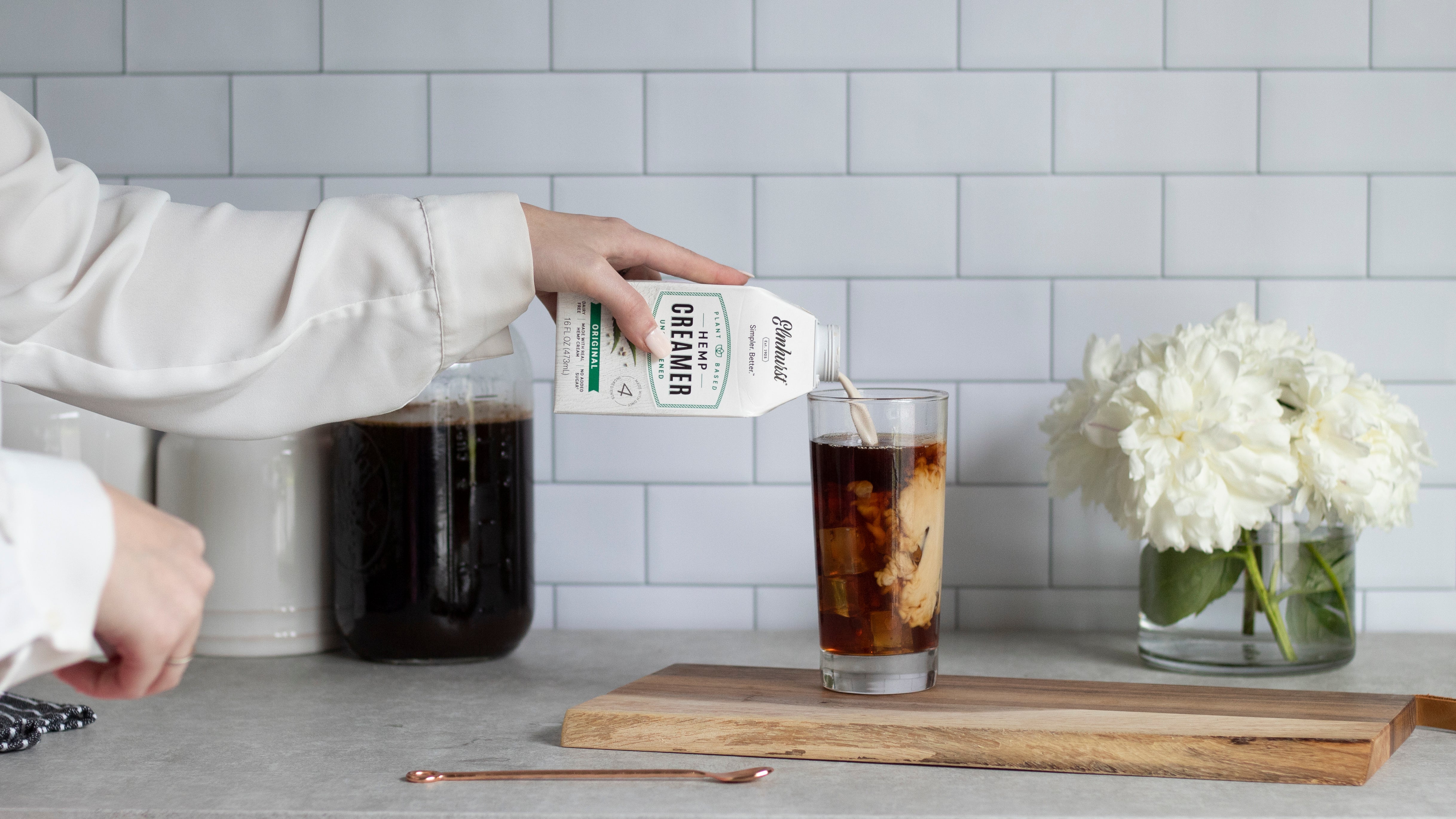 Hemp Coffee Creamer being Poured into a cup of iced coffee