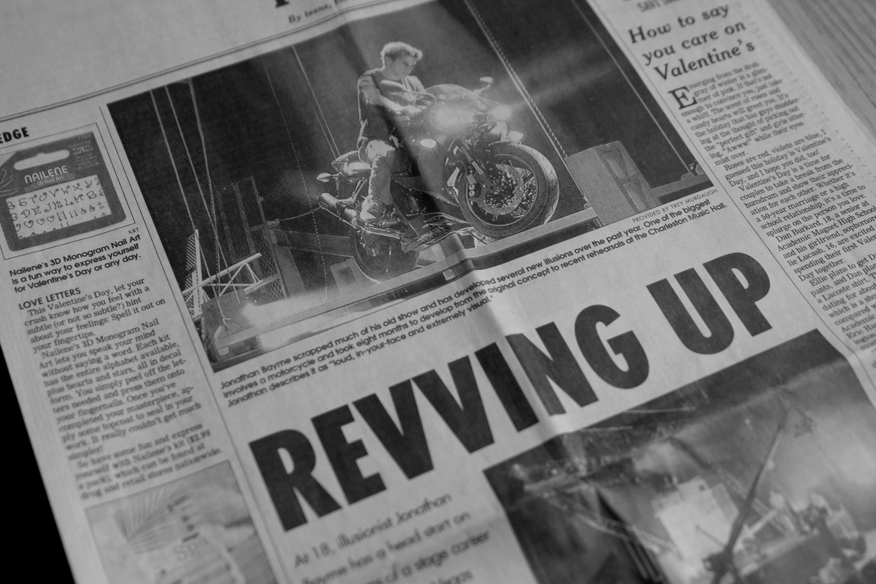 Newspaper clipping of Jonathan Bayme, founder of Theory11, on a motorcycle with a caption that reads "Revving Up", about a magic show he was performing at the age of 18 at the Charleston Music Hall in South Carolina.