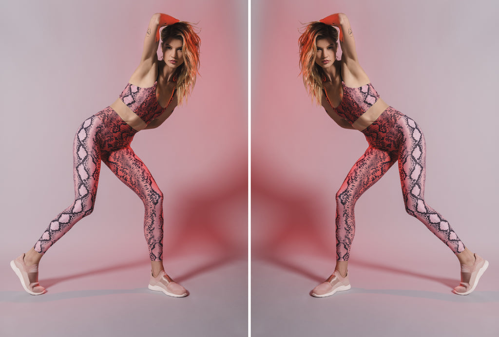 Model stretching in Snake Print Sports Bra Top and active legging in color pink ombre.