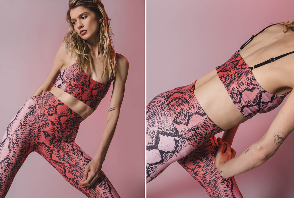 Model stretching in Snake Print Sports Bra Top and active legging in color pink ombre.