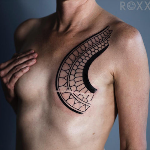 Tribal tattoo design that incorporate scar into the design