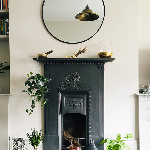 Brass vintage light in a living room interior with a fireplace 