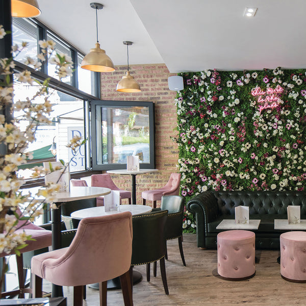 Floral wall in Bocca Social with brass industrial pendant lights