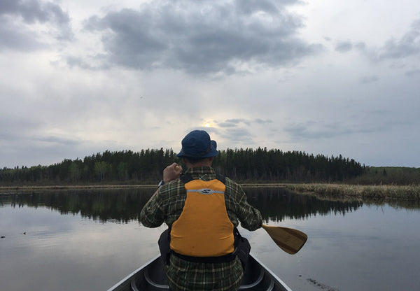 lowering sky over paddler on a lake 