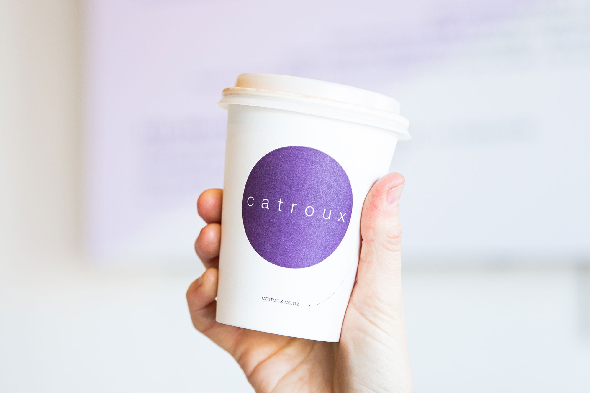 Person holding Catroux coffee cup at Catroux Cafe Auckland
