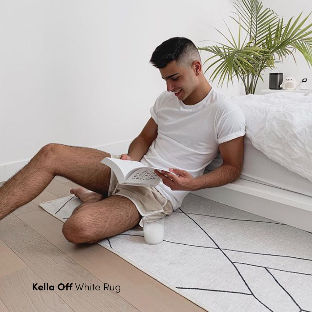 Man reading on Kella Off White Rug