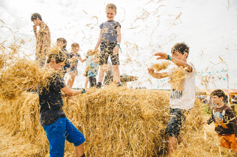 Kids playing in hay bales 