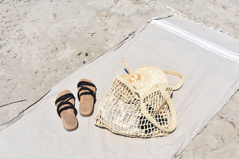 beach bag and black sandels on blanket