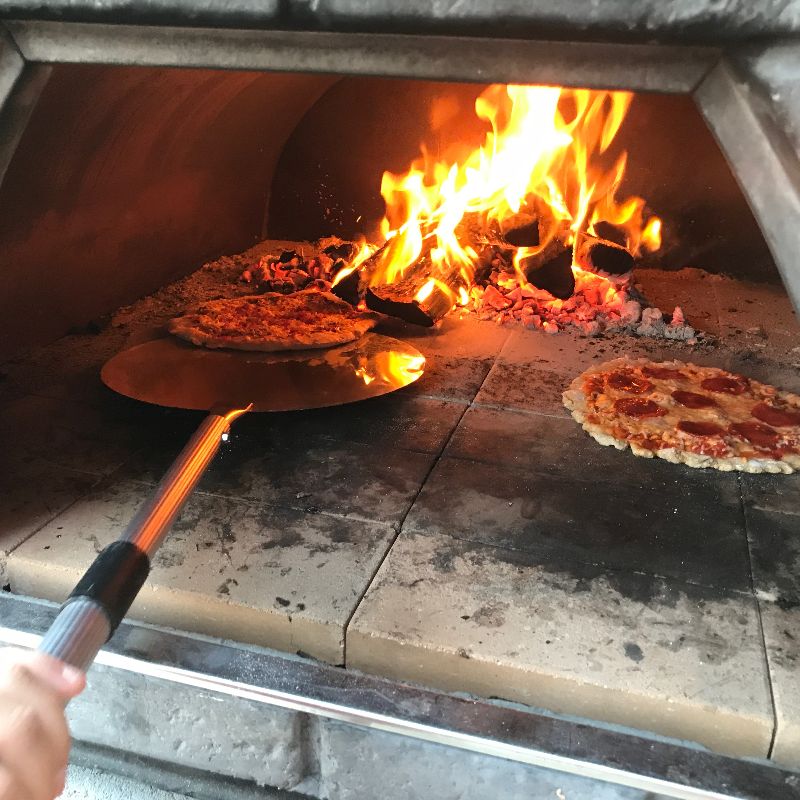Cooking pizza in the Maximus Prime pizza oven