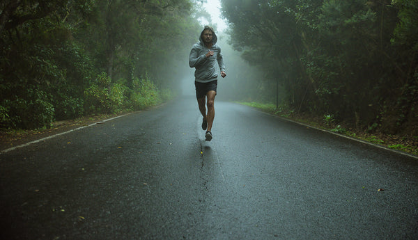 Athlete running in the rain on-road