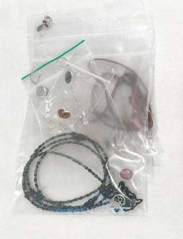 stacked jewelry in zipper bags