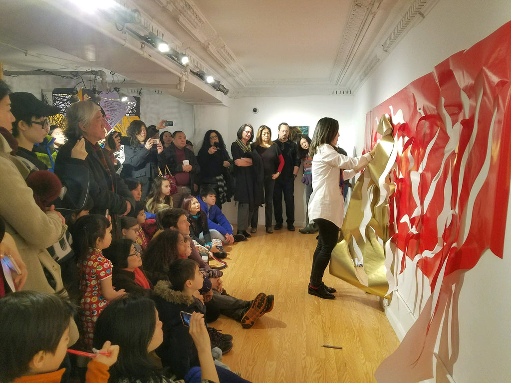 Artist Xin Song during a papercut performance