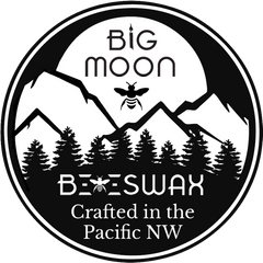big moon beeswax logo with large moon over mountains and a bee in front of the moon