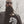Bearded man wearing seahorse skeleton tank top with blazer