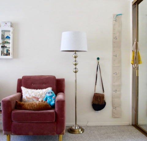 art-deco-lamp-velvet-chair-linen-height-marker-pop-of-color-bedroom