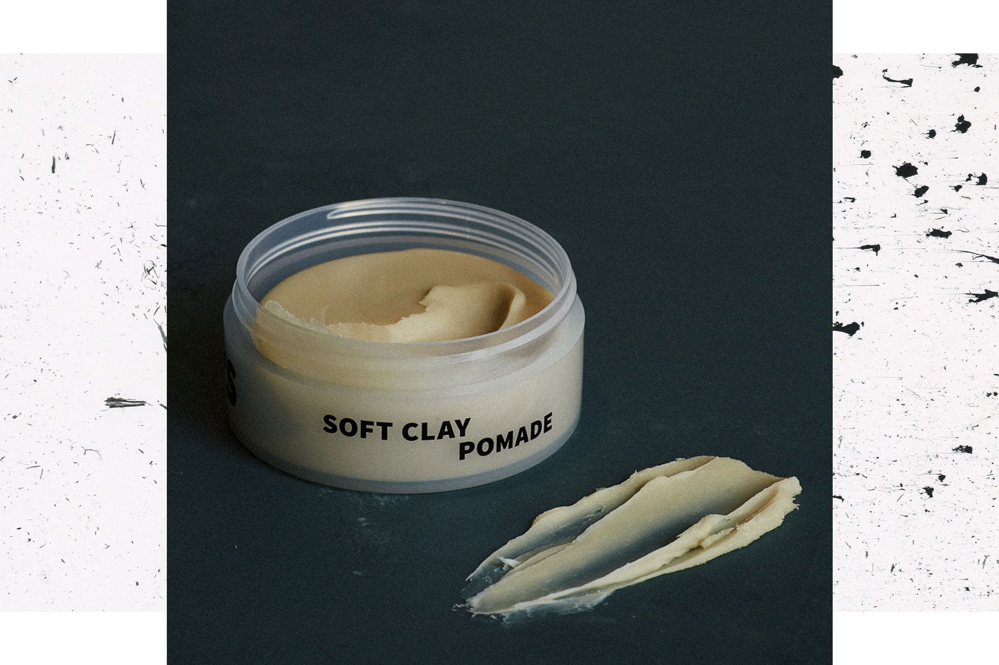 Image of Soft Clay Pomade on dark background with a swipe of product in the foreground
