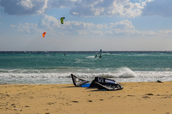 the sea with a kiteboard resting on the sand