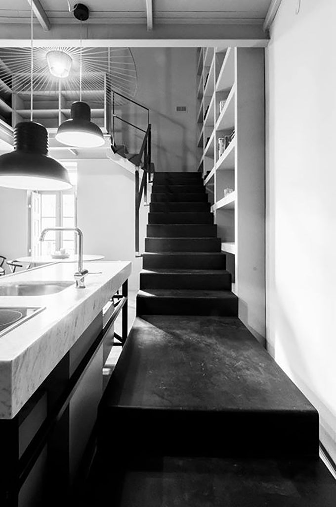 black staircase and kitchen island in bianco carrara apartment Malta