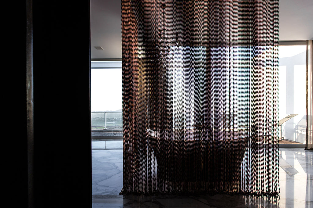 luxury bathtub hidden after a ball curtain hanging