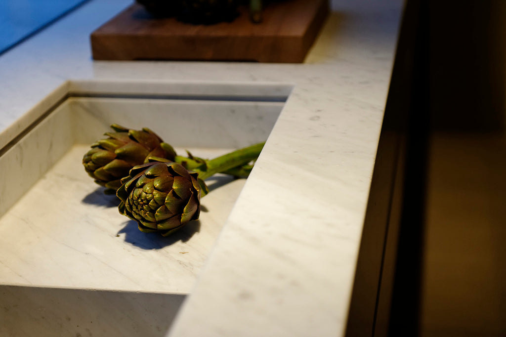 artichokes on bianco carrara kitchen countertop